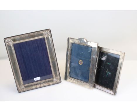 Three rectangular silver easel back photograph frames: the largest with bead and stylised foliate decoration, makers Carr's o