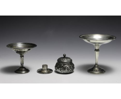 Includes a large and small compote, a dresser jar, and a candlestick insert. Both compotes have weighted bases. The larger co