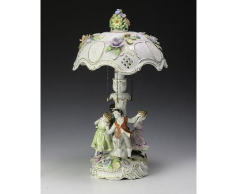 All porcelain, including lithopane shade. Figural base with four dancers, raised flowers, and gold trim. Lithopanes with clas