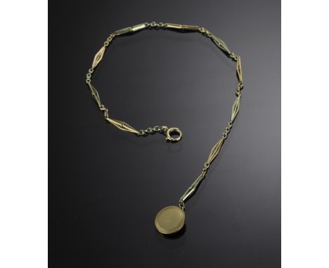 Marked and tested 14K with alternating links of white and rose gold with a gold waistcoat button at the end. Made by Cowen an