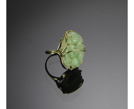 Marked and tested 14K with a carved jade stone surmounted by an approximately 2mm diamond. Total weight: 12.3 grams (.39 troy