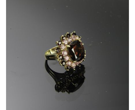Marked and tested 14K with a large center cushion cut garnet, approximately 13.75 ctw surrounded by 14 round cut Morganites a