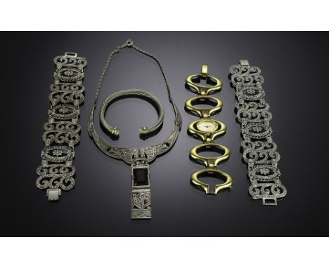 Five pieces of costume jewelry, including a silver metal cuff bracelet, a gold metal Trifari watch, a silver metal necklace w