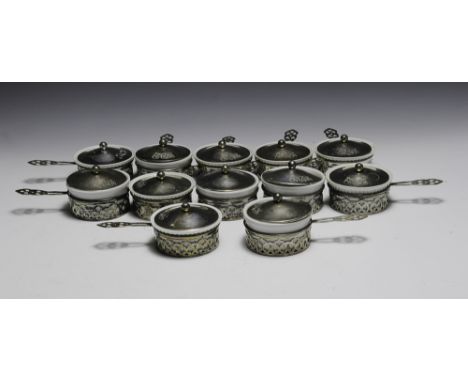 Twelve signed Reed and Barton sterling silver dessert dishes with porcelain inserts. There are a total of thirteen inserts. S