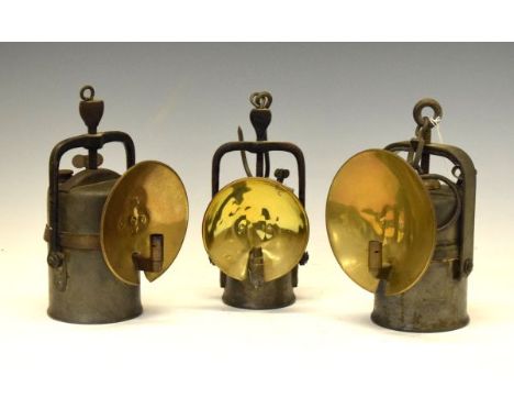 Two Premiere Lamp Engineering Co. Ltd Crestella carbide miners lamps, together with 'The Wolf Safety Lamp', tallest approx 24