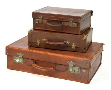 Three vintage leather suitcases, largest 60cm wide  