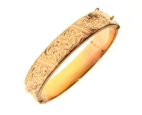9ct gold snap bangle of hollow design, one half with engraved foliate scroll work, 14.4g approx  