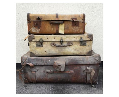 Three assorted vintage travel trunks to include; a vellum example and another brown leather stamped Finnegan Maker, together 