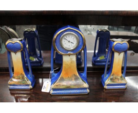 Ceramic mantle clock with matching vase garnitures, circa 1910