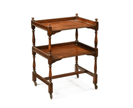 Oak trolley, with three quarter gallery to the top and shelf raised on turned supports with castors beneath, height 81 cm, wi