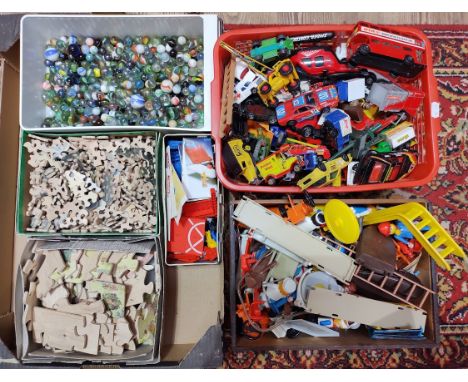 A collection of assorted toys comprising approximately 60 die-cast model cars, a tin of Space Watch Tower building blocks set