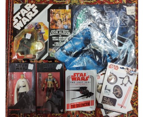 A mixed lot Star Wars collectables including two boxed Black Series figures, two t-shirts, Last Jedi book/model, sticker pack