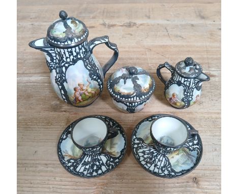 A KPM Art Nouveau style silver overlay and hand painted porcelain coffee set, circa 1900, comprising coffee pot, sugar and cr