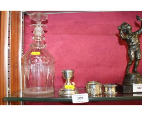 A pair of silver candlesticks; a silver serviette ring; two other serviette rings; and a Georgian decanter 