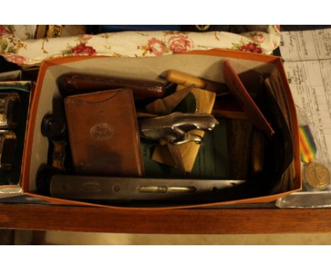 A box containing leather cigar case; a brass mounted spirit level; car mascot; opera glasses; post-cards etc.