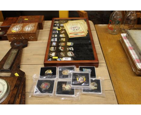 A collection of enamel decorated badges, some relating to the Titanic 