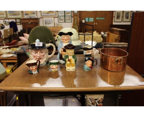 A collection of character jugs; a Beswick teapot; and a copper and brass twin handled dish 