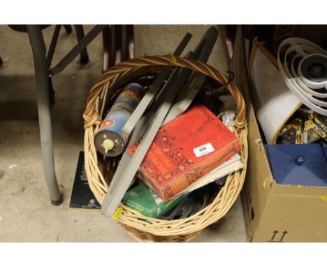 A basket of various sundries to include coat hangers and books 