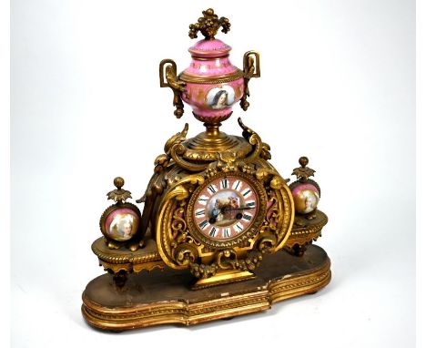 A 19th century French ormolu and pictorial pink porcelain mounted eight-day two train mantel clock surmounted by an urn, on g