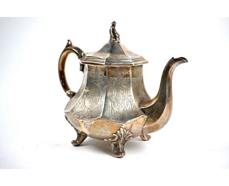 A Victorian silver teapot with engraved decoration, surmounted by cast Chinese figural finial, on scroll feet, James Dixon &a