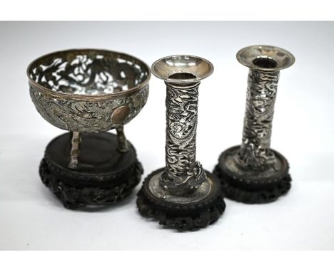 An early 20th century Chinese export silver 'Tuck Chang' pierced bowl embossed with two dragons disputing a vacant circular f