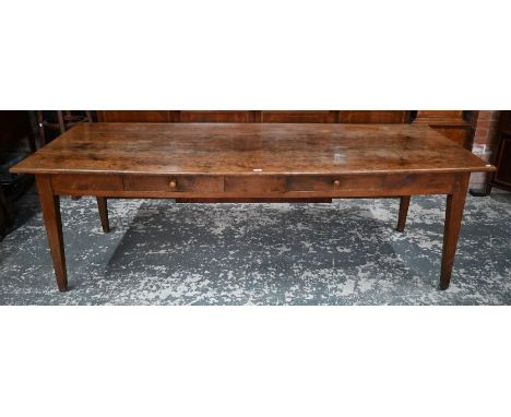 A 19th century French fruitwood dining table, the four plank top over two frieze drawers to one side, raised on square taperi