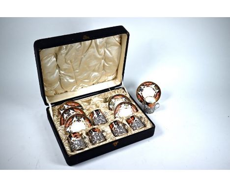 A cased set of six Royal Crown Derby Imari coffee cans and saucers with floral and scroll-pierced silver cup-holders, Army &a