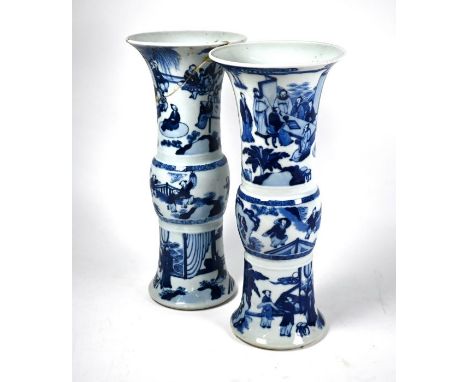 A pair of Chinese blue an white gu-form beaker vases in the Kangxi style but probably 19th century, late Qing dynasty, painte