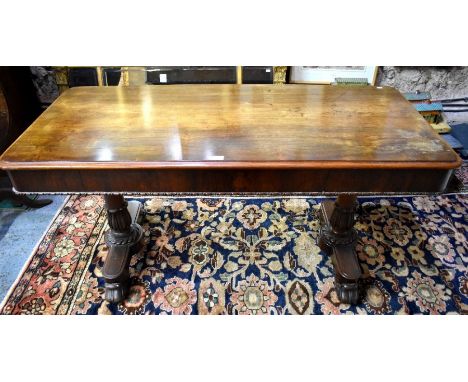 A Victorian rosewood library/centre table, the rectangular top with rounded corners over a plain frieze raised on turned acan