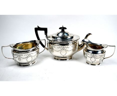 An Edwardian Adam Revival silver three-piece tea service engraved with ribbons and garlands, James Dixon &amp; Sons Ltd., She