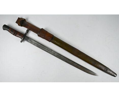 A World War I US Army bayonet with 43 cm fullered Remington blade dated 1917, two-piece wooden grip, in leather scabbard with