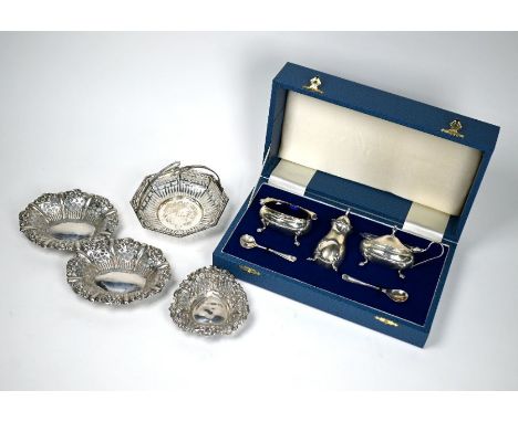 A cased three-piece silver condiment set c/w spoons, Birmingham 1989, to/w three late Victorian pierced small bonbon dishes, 