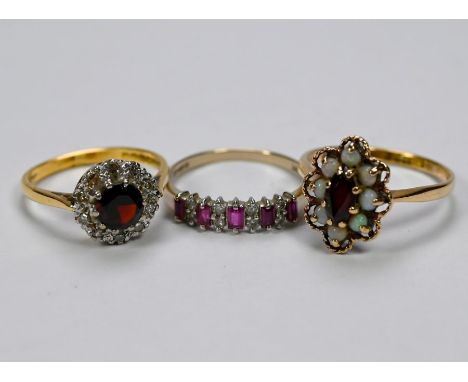 Three various rings - 18ct yellow gold diamond and ruby cluster, size O/P, a ruby and diamond half eternity ring set baguette