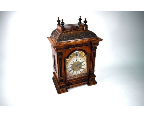 An Edwardian oak cased mantel clock with 8-day two train movement, the arched brass dial with silver chaper ring and subsidia