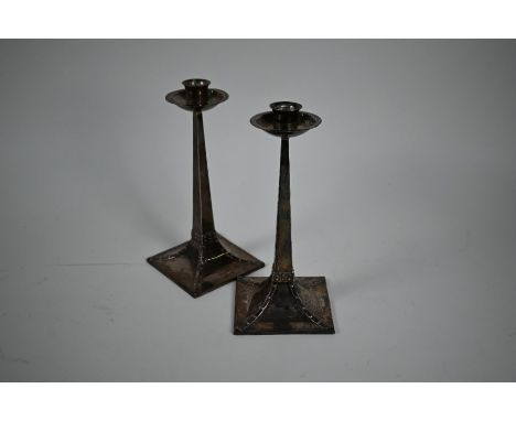 A pair of Edwardian Arts &amp; Crafts loaded silver candlesticks&nbsp;in the manner of Charles Voysey,&nbsp;of&nbsp;square ta