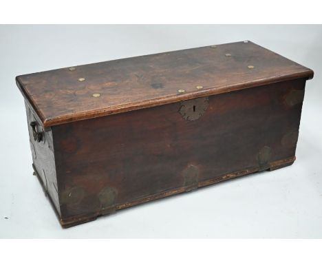 A large antique Indian brass bound camphorwood trunk, with folding carrying handles to the sides, on block feet, 142 cm w x 5