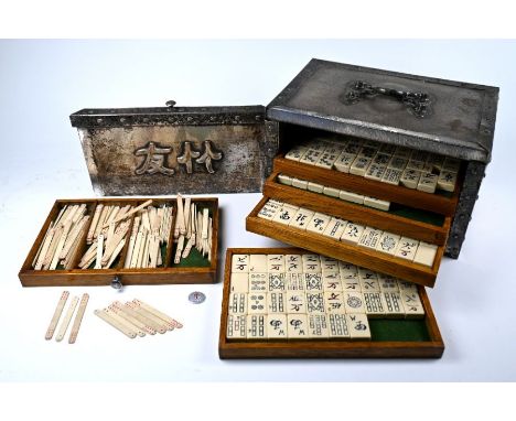 An Arts &amp; Crafts style mah jong set, with five drawers containing composite tiles and sticks, the case with hammered deco