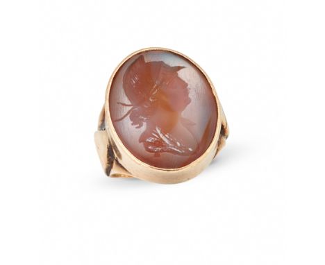 A mid 20th century gold mounted hardstone intaglio ring, the oval intaglio engraved to depict the simplified head profile of 