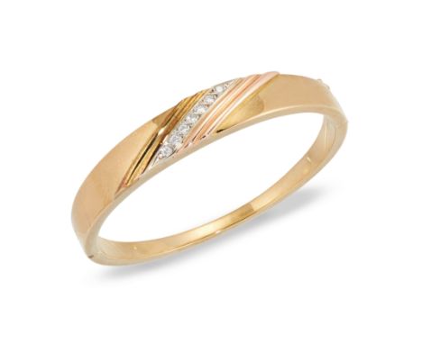 A hollow three colour tapering bangle, with a row of brilliant cut diamonds obliquely set, to box catch, indistinctly stamped