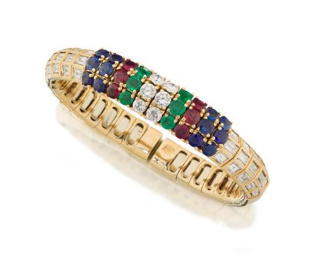 A three row gem and diamond set sprung torque bangle, with rows of brilliant cut diamonds, emeralds, rubies and sapphires in 