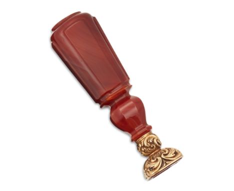 A 19th century gold and carnelian desk seal, the carnelian matrix intaglio engraved with the arms and crest of Gaynsford/Gain