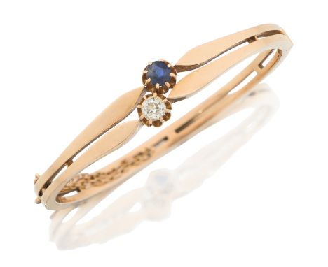 A sapphire and diamond set bangle, with an old cut diamond and mixed cut sapphire obliquely set in claw collets, to two row b