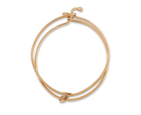 Gucci. A 9ct gold bangle, composed of two interconnecting wirework bangles with bead terminals, signed Gucci, London hallmark