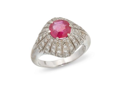 A ruby and diamond bombé cluster ring, the single cushion-shaped ruby weighing approximately 1.50 carats, within pavé diamond