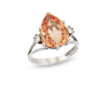 A topaz and diamond ring,&nbsp;the pear cut orange topaz approximately 12.3 x 9.6mm, with a brilliant cut diamond at each sid