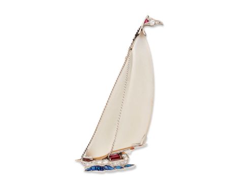 An Art Deco rock crystal sailing boat brooch, with frosted rock crystal sails, ruby and diamond set burgee and hull atop a ca