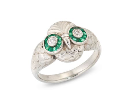 A diamond and emerald owl ring, designed as an owl's head with old cut diamond and calibre cut emerald target cluster eyes, t