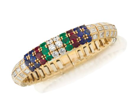 A three row gem and diamond set sprung torque bangle, with rows of brilliant cut diamonds, emeralds, rubies and sapphires in 