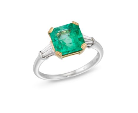 An emerald and diamond three stone ring, the square step cut emerald with a pair of tapered baguette cut diamonds at each sid