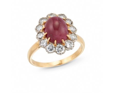 A French ruby and diamond cluster ring, the central cabochon ruby in claw setting with brilliant-cut diamond border, French a